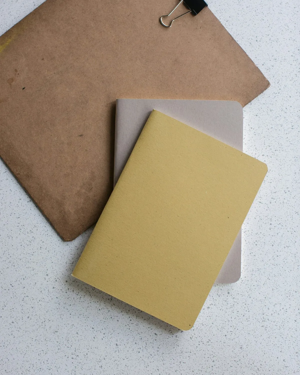 A notebook and clipboard on a desk