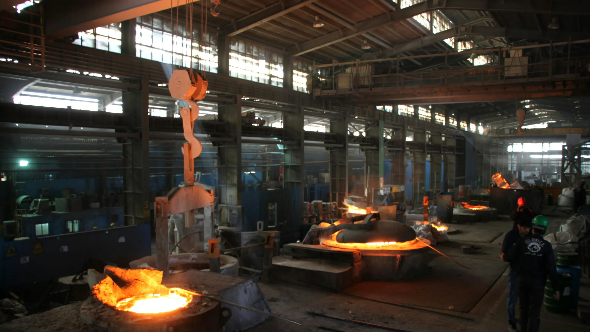 Molten metal being poured inside a foundry